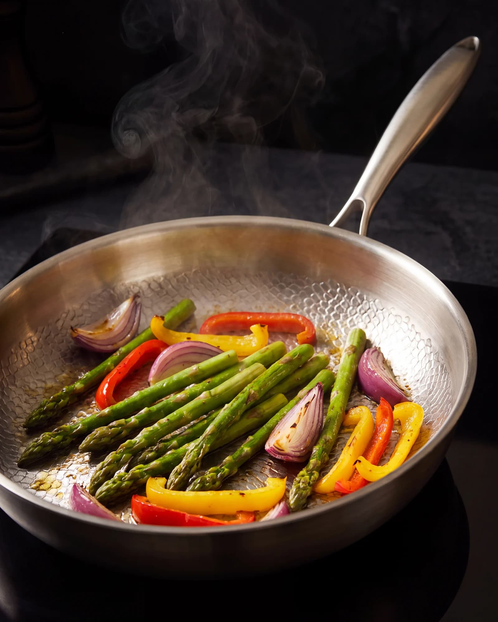 Vegetables searing in a titanium pan