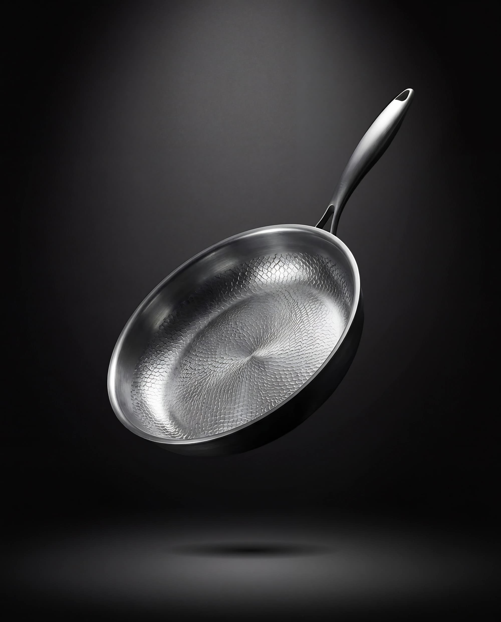 Titanium pan 24 cm floating against a dark backdrop