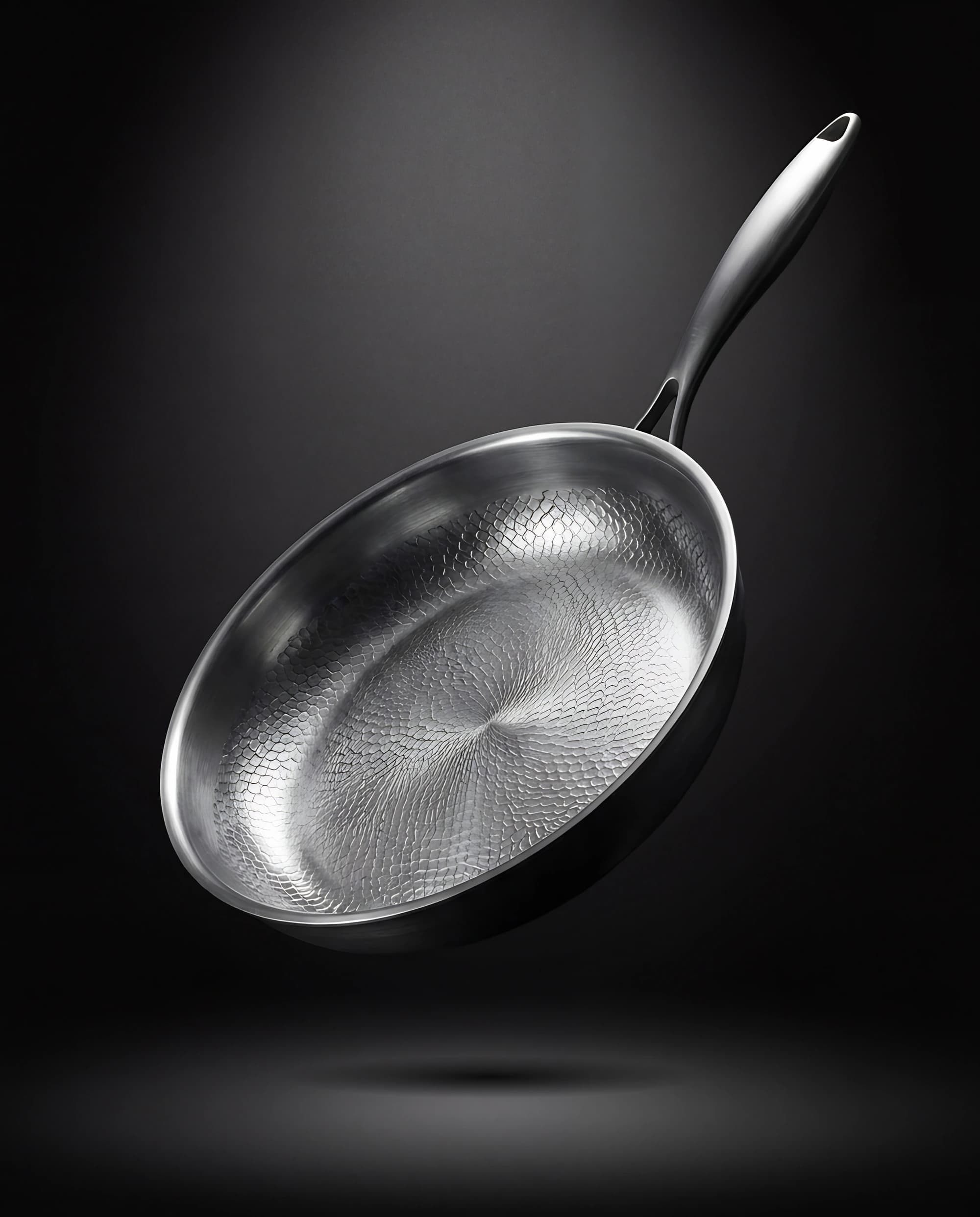 Titanium pan 28 cm floating against a dark backdrop