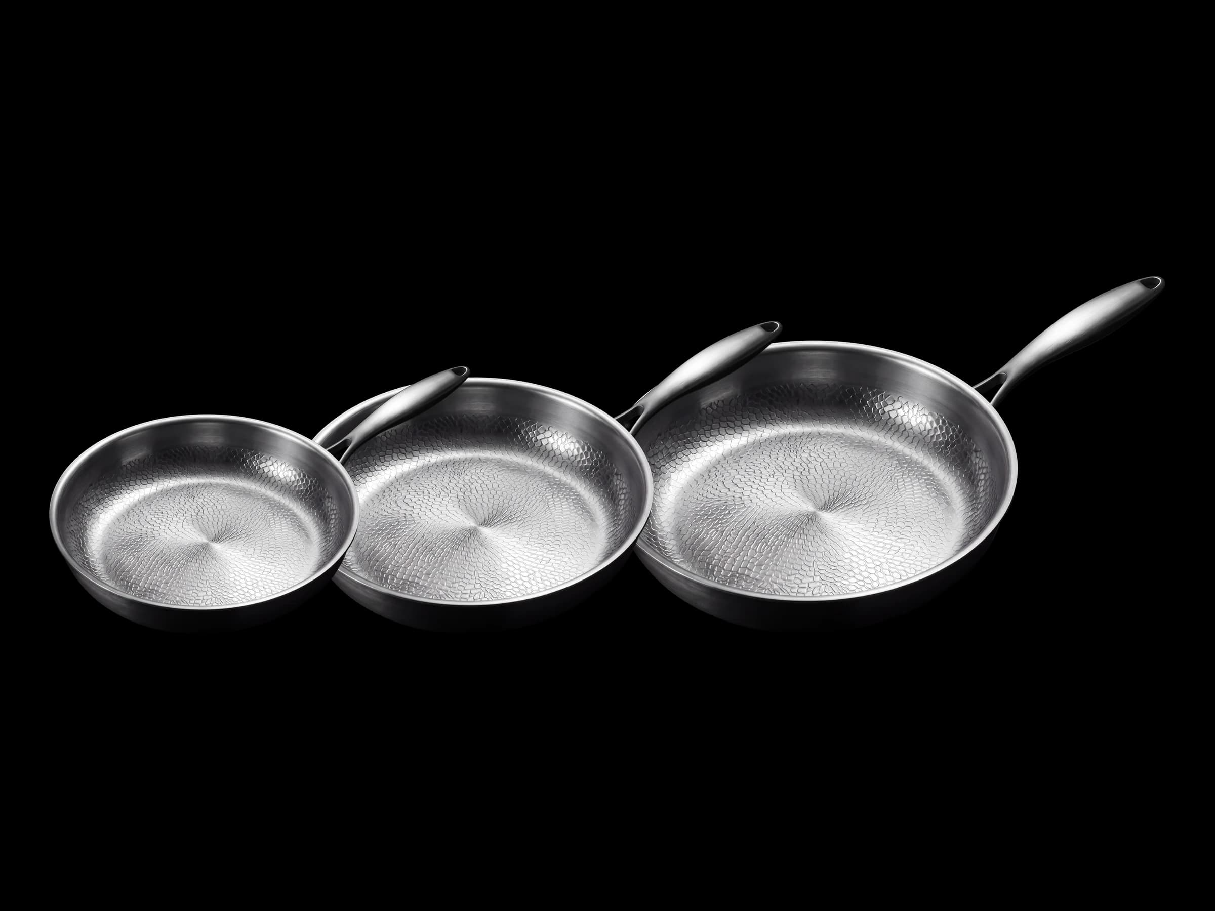 The 24, 28 and 32 cm titanium pans together, three-quarter view